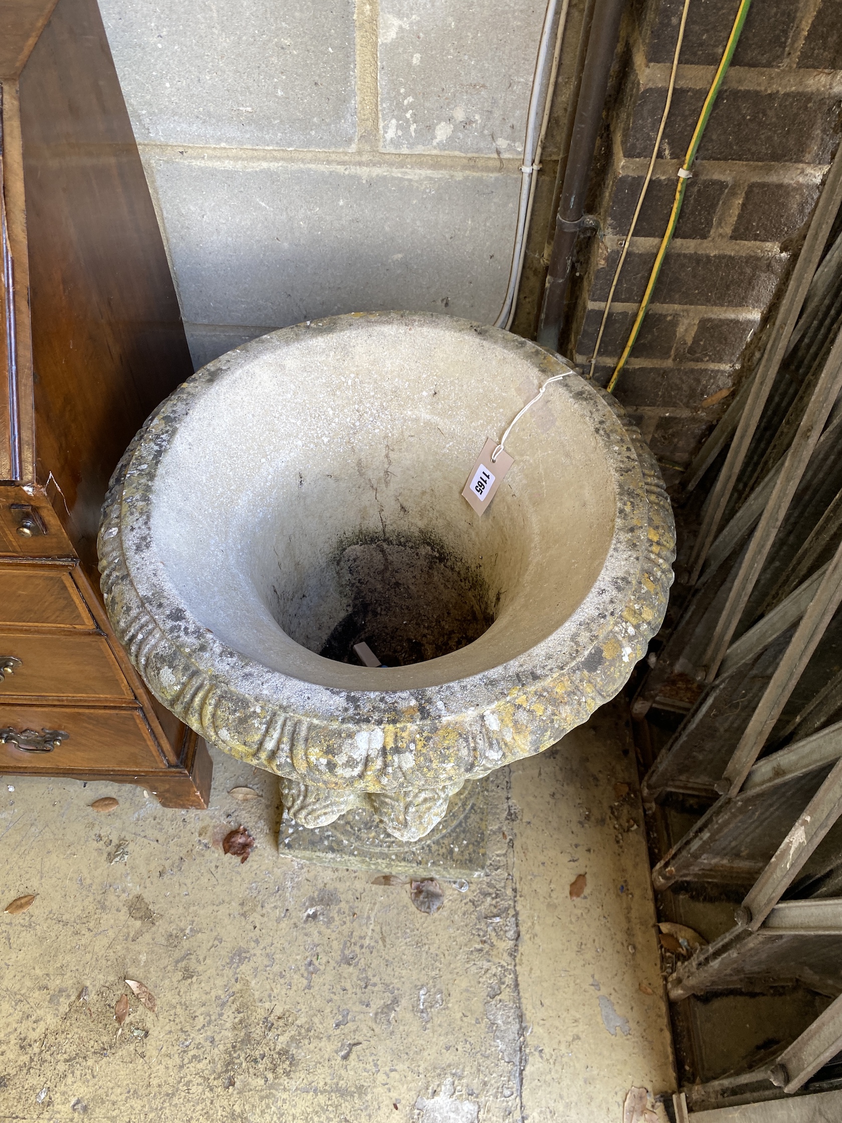A circular reconstituted stone campana garden urn, diameter 48cm, height 63cm